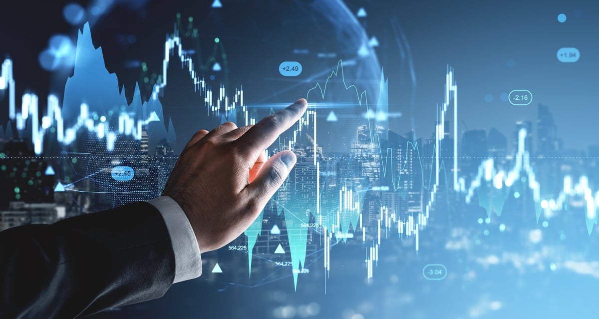 Analyst reviewing global financial market data on a holographic display